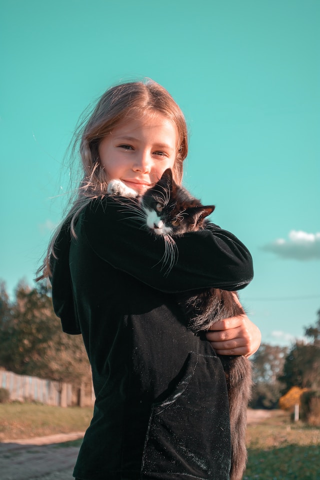Girl with a cat in her hands